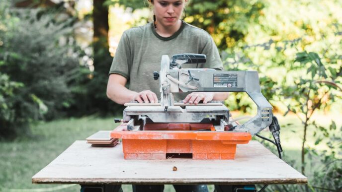 A polished table saw in a sunlit workshop surrounded by woodworking tools and materials.