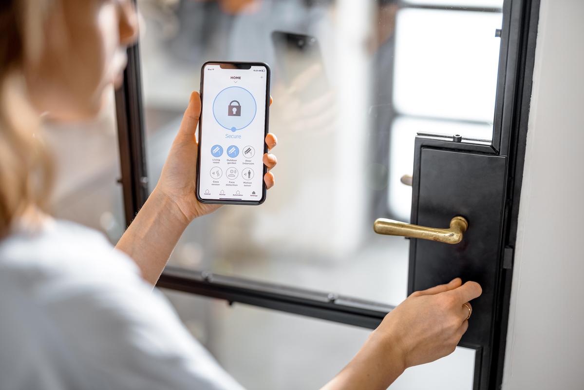 Sleek smart lock on a contemporary home door, illuminated by warm evening light.